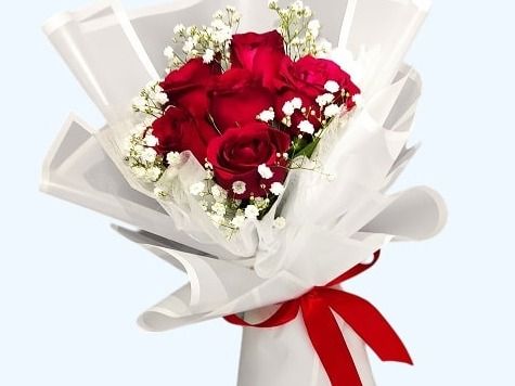 Fresh red roses in white wrapping